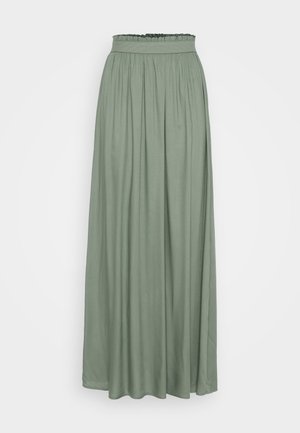 Fustă lungă, fluidă, de culoare verde deschis, realizată dintr-un material ușor, cu un tiv elastic strâns și pliseuri verticale.