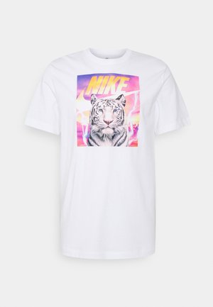 White T-shirt with a colorful graphic of a white tiger and large yellow "NIKE" text against a sunset sky background.
