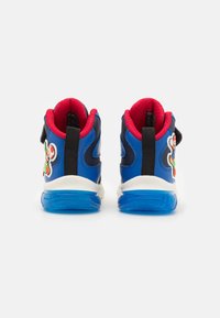 Blue high-top sneakers feature a red mesh lining, white midsole, black accents, and a colorful character patch on the outer side.