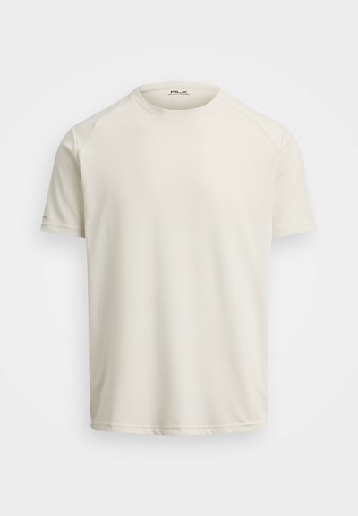 Lys kremfarget T-skjorte med kort erme laget av myk, pustende stoff, med rund hals og raglanermer. Minimalistisk design, sømløse sider.