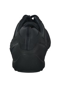 Black athletic shoe with a textured fabric upper, rubber sole, and prominent rear pull tab; features a smooth finish and stitched accents.