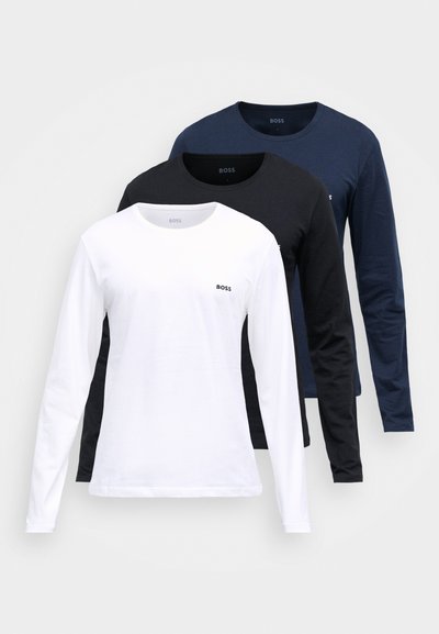 Ensemble de trois T-shirts à manches longues : blanc, noir et bleu marine. Matière en coton avec col rond et petit logo sur la poitrine.