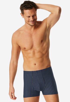 Laivastonsiniset bokserit, joissa monivärisiä pystysuoria raitoja, valmistettu pehmeästä kankaasta, kapealla istuvuudella ja muotoillulla etutaskulla.