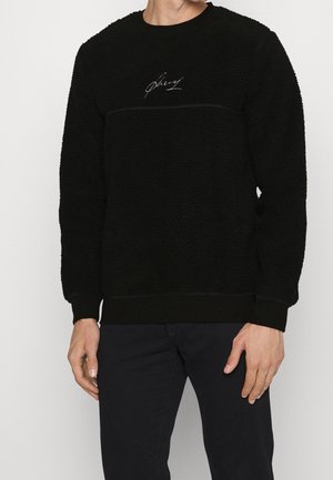 Zwarte fleece sweatshirt met een gestructureerd oppervlak, ronde halslijn, subtiele stikdetails en een geborduurd logo op de borst.
