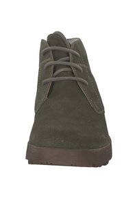 Stivaletti alla caviglia in suede verde oliva con punta arrotondata, tre coppie di occhielli e una suola piatta in gomma marrone. Texture liscia con dettagli di cucitura.