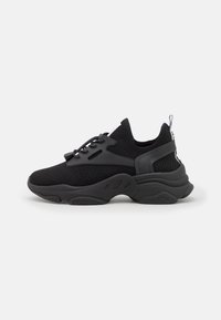 Black mesh sneakers with a textured upper, rubber sole, and contrasting accents. Features a lace-up design and a pull tab at the heel.
