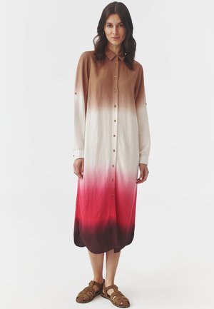 Long button-up dress featuring an ombre gradient from brown to pink, with a soft texture and rolled cuffs, paired with brown sandals.