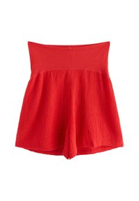 Punaiset shortsit, joissa on teksturoitu alaosa ja sileä ylävyö. Kangas on kevyt ja siinä on kerätty muotoilu.