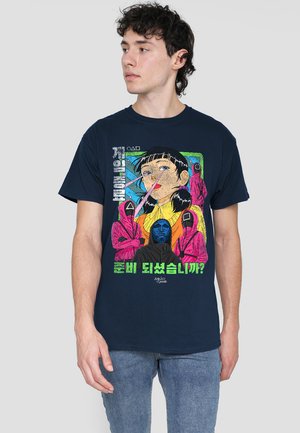 Navy cotton t-shirt featuring a colorful graphic print with a character, abstract shapes, and text in multiple languages. Regular fit.