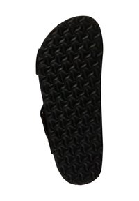 Suela de zapato de goma negra con un patrón de ondas texturizado y elevado para tracción. El borde es ligeramente redondeado con un acabado suave.