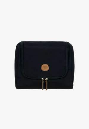 Zwarte stoffen reistas met een klep-sluiting, voorzien van een tan leren logo patch en dubbele gouden ritsen met bruine accenten.