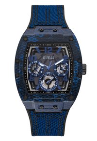 Reloj texturizado azul con caja de acero inoxidable negro, forma octagonal, esfera multifuncional y correa de tela azul con detalles de costura.