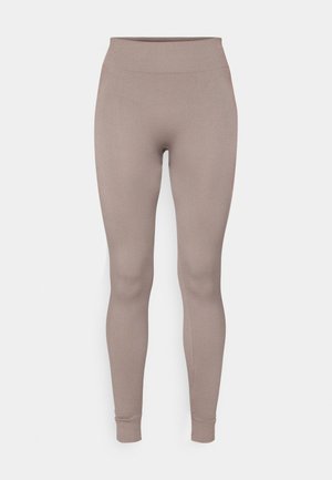 Leggings côtelés dans une douce couleur taupe, avec une taille haute, une coupe slim et des chevilles fuselées. Fabriqués en tissu texturé et extensible.