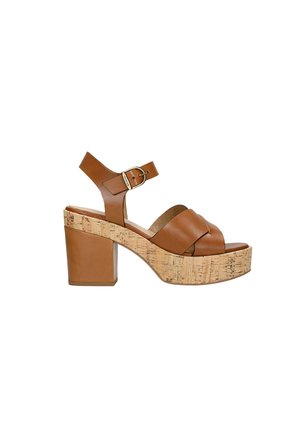 Brown leather platform sandals with a cork block heel, featuring crossed straps and an adjustable ankle buckle.