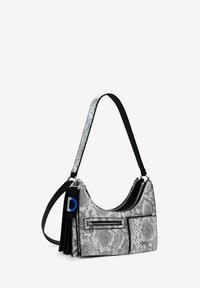 Hobo bag in black and white snake print, featuring silver hardware, a zip closure, and a detachable charm with a blue letter "D."