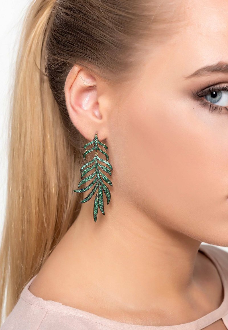 Green leaf-shaped earrings made of metal with sparkling accents. Features a layered leaf design, suspended from a small hook.