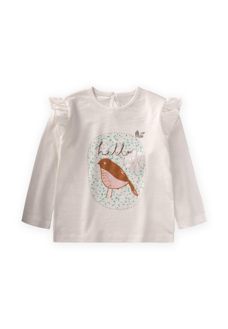 Pitkähiha valkoinen paita, jossa on rypytetyt hartiat, ruskean linnun grafiikka ja "hei"-teksti vaaleansinisen kuviopohjan päällä.