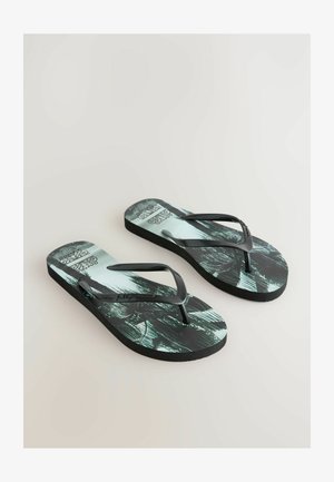 Fekete papucsok, teal és fekete mintázattal rendelkező talppal, vékony gumipántokkal és texturált talppal.