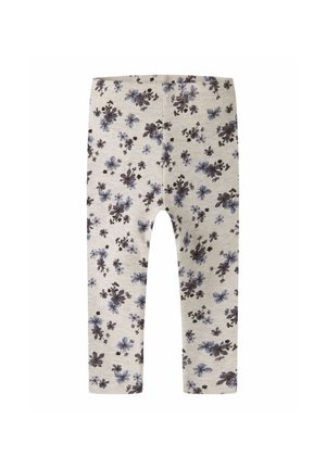Leggings beige pour enfants avec un motif floral bleu et noir recouvrant l'ensemble et une ceinture élastique.