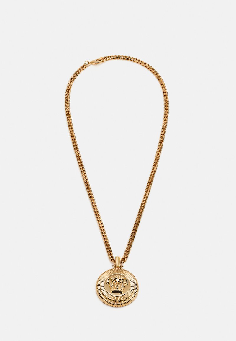 Gold chain necklace with a round pendant featuring a raised lion head design and textured border, showcasing a polished metal finish.