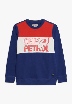 Blaues Sweatshirt mit roten und weißen Akzentpaneelen, darauf steht in kräftigem Rot "DNM PETROL". Hergestellt aus weichem Stoff, mit Rundhalsausschnitt.
