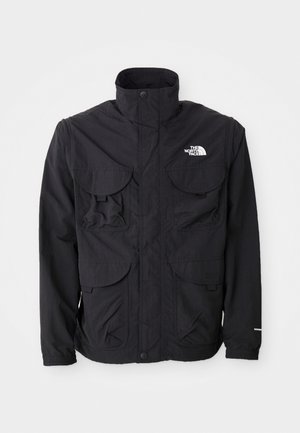 Black jacket with a high collar, two front flap pockets, a zippered closure, and logo on the upper right side. Lightweight, outdoor design.