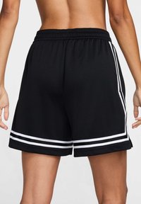 Black athletic shorts with an elastic waistband, featuring two white stripes on the sides and above the hem, smooth texture.
