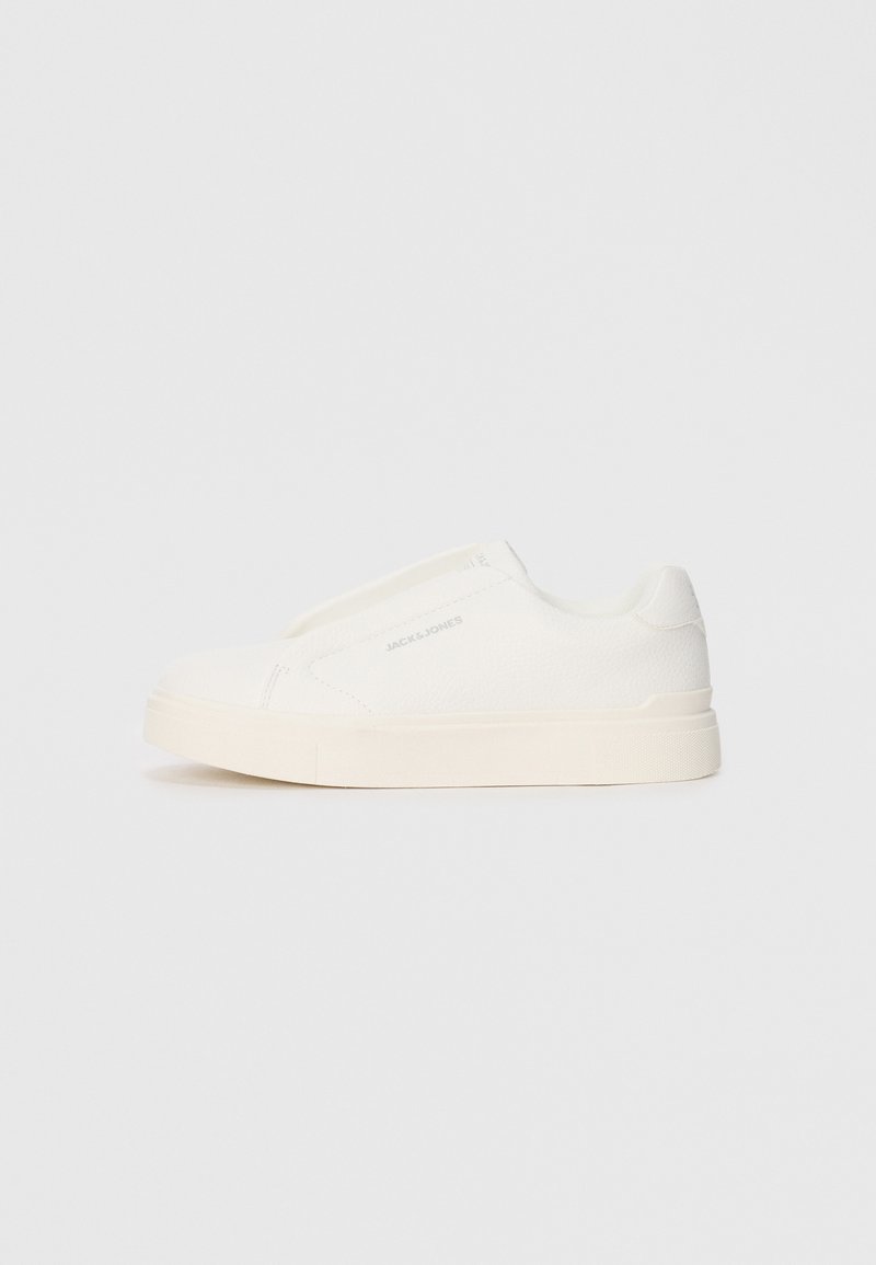 White slip-on sneakers with a textured surface, a thick sole, and minimalistic design. Features brand logo on the side.