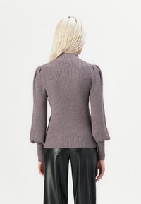 Lilac ribbed sweater featuring a high collar, voluminous long sleeves, and a fitted waist, paired with black pleather pants.
