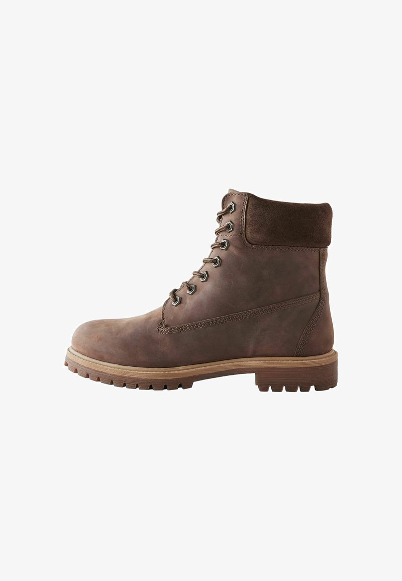 Brown leather ankle boot with a suede cuff, lace-up design, round toe, and rugged rubber sole with pronounced treads for traction.