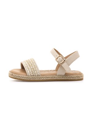 Sandales beige avec dessus en textile tissé et bride de cheville réglable, ornées de détails en corde de jute le long de la semelle et d'une semelle plate.