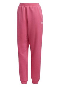 Pantalon de survêtement rose avec une taille élastique et des poignets à la cheville. Fabriqu é en tissu doux, il présente un petit logo blanc sur la cuisse gauche.