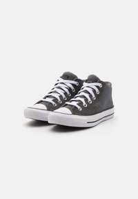 Gray canvas high-top sneakers with white laces, rubber toe cap, and a white midsole featuring black horizontal stripes.