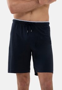 Marineblauwe katoenen shorts met een elastische tailleband, trekkoordsluiting en zijzakken. Glad materiaal met een relaxte pasvorm en knielange lengte.