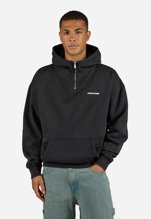 Black pullover hoodie with a front zipper, large hood, and front pocket. Features a white logo on the chest. Fabric appears soft and thick.
