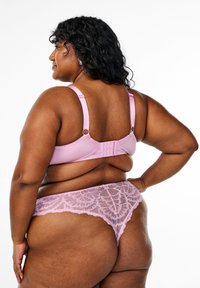 Pink lace lingerie set featuring a soft bra with adjustable straps and hooks, paired with sheer lace panties displaying a floral pattern.