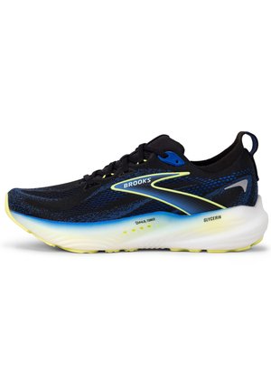 Baskets de course noires et bleues avec une tige en maille, accents jaunes et une semelle blanche rembourrée. Présente le logo "Brooks" et un motif texturé.