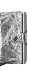 Metallic silver wallet with a textured leather exterior, featuring a snap closure and an aluminum cardholder integrated on the side.