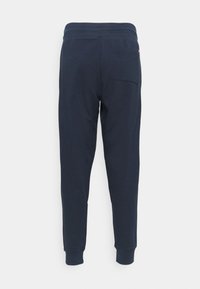 New Balance STACKED LOGO - Pantalones deportivos - eclipse