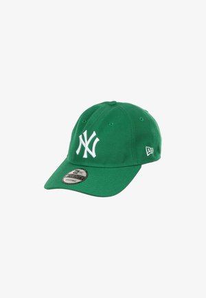 Green New York Yankees cap, cotton material, six-panel design, white logo, adjustable strap, curved brim, textured surface, visible stitching.