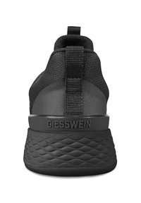 Black athletic shoe featuring a knit upper, cushioned sole with a textured pattern, and a prominent heel tab with the brand name.