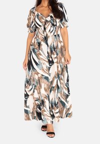 Sukienka maxi ma abstrakcyjny kwiatowy nadruk w kolorach teal, brązowym i kremowym, z krótkimi bufkami, dopasowanym gorsetem i rozkloszowanym dołem.