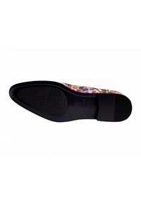 Black shoe sole with textured grip, featuring multicolored floral patterns on the upper material and contrasting blue stitching detail.