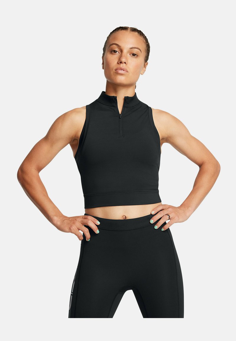 Svart zippered träningskort topp med hög krage, åtsittande design och slät textur, matchat med svarta leggings.