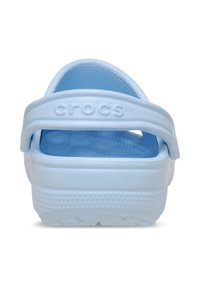 Light blue Crocs clogs featuring a thick heel, textured footbed, and an adjustable strap for a secure fit. Made from durable rubber material.