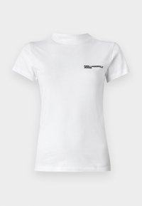 Witte katoenen T-shirt met een ronde hals. Heeft korte mouwen en een zwart logo met de tekst "KARL LAGERFELD JEANS" op de linkerborst.