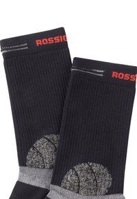 Calze nere con texture a coste, dotate di logo rosso "ROSSIGNOL", banda grigia e dettagli grigi a motivo vicino alla caviglia.