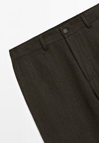 Dark brown pants showing waistband with belt loops and a button closure on a plain white background.