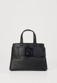 Black leather handbag with a structured shape, featuring short handles, a wide strap with a rectangular logo accent, and textured finish.