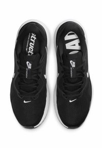 Scarpe da ginnastica nere con una tomaia in rete traspirante, lacci piatti e intersuola in schiuma. Presenta un logo Nike bianco e la scritta "Run Structure" sulla soletta.